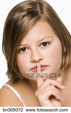Stock Photo - teenage girl gesturing 
for silence. fotosearch 
- search stock 
photos, pictures, 
images, and photo 
clipart