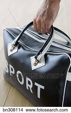 Stock Photo - man holding duffel 
bag saying sport. 
fotosearch - search 
stock photos, 
pictures, images, 
and photo clipart