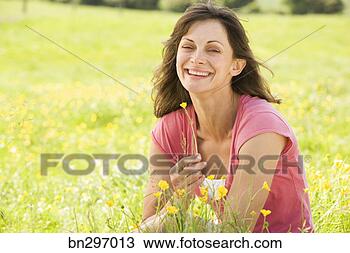Stock Photo - smiling woman 
in field of wildflowers. 
fotosearch - search 
stock photos, 
pictures, images, 
and photo clipart