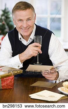 Stock Photo - man with champagne 
and christmas 
card. fotosearch 
- search stock 
photos, pictures, 
images, and photo 
clipart