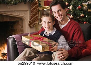 Stock Photography - father and son 
with christmas 
present. fotosearch 
- search stock 
photos, pictures, 
images, and photo 
clipart