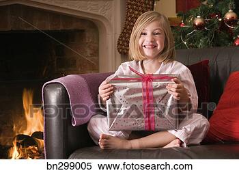 Stock Image - girl holding christmas 
present. fotosearch 
- search stock 
photos, pictures, 
images, and photo 
clipart