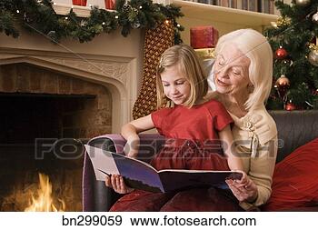 Stock Photograph - grandmother and 
girl reading book 
at christmas. 
fotosearch - search 
stock photos, 
pictures, images, 
and photo clipart