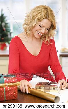 Stock Photo - woman wrapping 
presents. fotosearch 
- search stock 
photos, pictures, 
images, and photo 
clipart