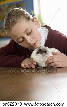 Stock Photograph - girl petting guinea 
pig. fotosearch 
- search stock 
photos, pictures, 
images, and photo 
clipart