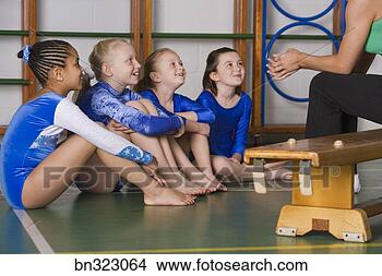 Stock Photo - coach talking 
to gymnastics 
girls team. fotosearch 
- search stock 
photos, pictures, 
images, and photo 
clipart