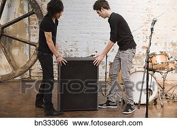Stock Photo - men moving band 
equipment. fotosearch 
- search stock 
photos, pictures, 
images, and photo 
clipart