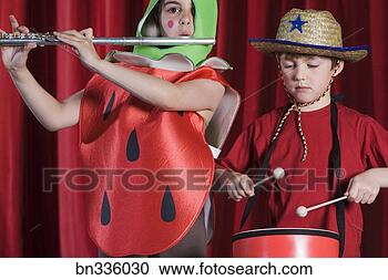 Stock Photography - students in costumes 
playing instruments 
on stage. fotosearch 
- search stock 
photos, pictures, 
images, and photo 
clipart