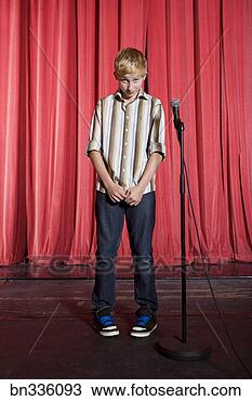 Stock Photo - upset boy on stage 
boy microphone. 
fotosearch - search 
stock photos, 
pictures, images, 
and photo clipart