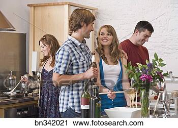 Stock Photography - friends in kitchen 
preparing meal. 
fotosearch - search 
stock photos, 
pictures, images, 
and photo clipart