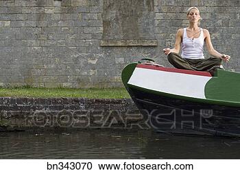Stock Photography - woman doing yoga 
on boat. fotosearch 
- search stock 
photos, pictures, 
images, and photo 
clipart
