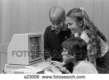 Stock Photo - 1980s boy sitting 
in front of computer 
playing games 
boy & girl. fotosearch 
- search stock 
photos, pictures, 
images, and photo 
clipart