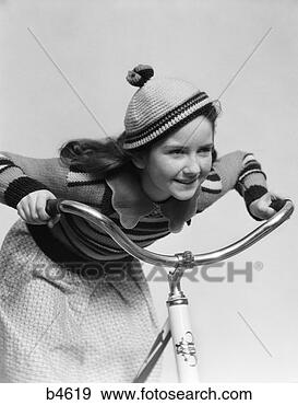 Stock Photograph - 1930s smiling 
eager little girl 
knit cap riding 
bike. fotosearch 
- search stock 
photos, pictures, 
images, and photo 
clipart