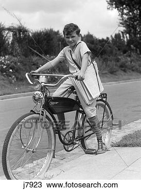 Stock Photo - 1940s boy on an 
elgin bike carrying 
newspapers in 
a sling wearing. 
fotosearch - search 
stock photos, 
pictures, images, 
and photo clipart