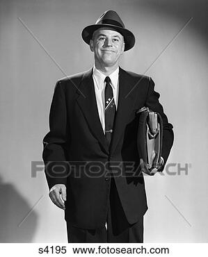 Stock Image - 1950s 3 4 length 
portrait smiling 
man salesman businessman 
holding. fotosearch 
- search stock 
photos, pictures, 
images, and photo 
clipart