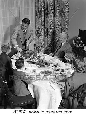 Stock Photo - 1950s 3 generations 
thanksgiving dinner 
with father carving 
turkey. fotosearch 
- search stock 
photos, pictures, 
images, and photo 
clipart