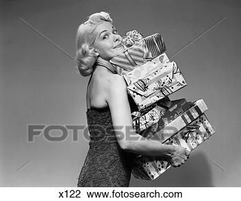 Stock Photo - 1950s blonde woman 
strapless dress 
carrying stack 
gift wrapped. 
fotosearch - search 
stock photos, 
pictures, images, 
and photo clipart