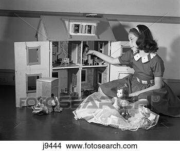 Stock Photo - 1950s girl playing 
with doll house 
& dolls toys. 
fotosearch - search 
stock photos, 
pictures, images, 
and photo clipart