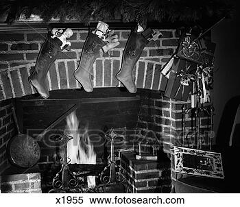 Stock Image - 1960s christmas 
stockings full 
of toys hanging 
over fireplace. 
fotosearch - search 
stock photos, 
pictures, images, 
and photo clipart