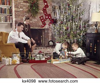 Stock Photo - 1960s family in 
living room christmas 
tree boys playing 
with toys. fotosearch 
- search stock 
photos, pictures, 
images, and photo 
clipart
