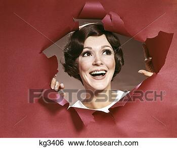 Stock Photo - 1960s portrait 
of happy young 
woman looking 
through torn paper 
joy. fotosearch 
- search stock 
photos, pictures, 
images, and photo 
clipart