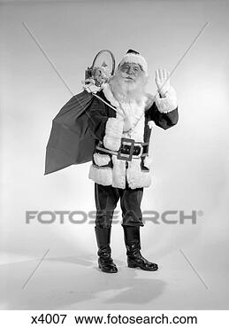 Picture - 1960s smiling 
santa with a bag 
of toys over his 
back waving jolly. 
fotosearch - search 
stock photos, 
pictures, images, 
and photo clipart