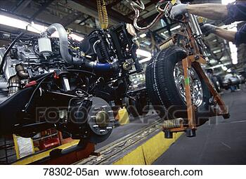 Stock Photo - automobile factory 
worker installing 
tires. fotosearch 
- search stock 
photos, pictures, 
images, and photo 
clipart