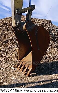 Picture - backhoe shovel 
and pile of tree 
bark shavings. 
fotosearch - search 
stock photos, 
pictures, images, 
and photo clipart