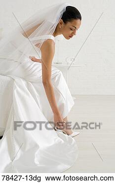 Stock Photo - bride adjusting 
strap of shoe. 
fotosearch - search 
stock photos, 
pictures, images, 
and photo clipart