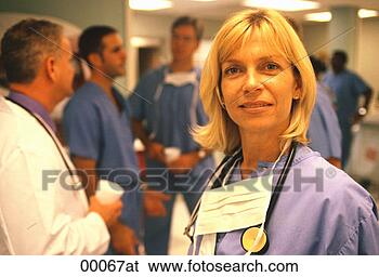Stock Photo - a close-up of 
a caucasian female 
doctor looking 
at the viewer 
while. fotosearch 
- search stock 
photos, pictures, 
images, and photo 
clipart