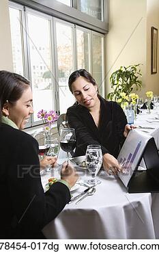 Stock Photo - two businesswomen  discussing work  in restaurant.  fotosearch - search  stock photos,  pictures, images,  and photo clipart
