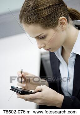 Stock Photo - businesswoman 
using pda. fotosearch 
- search stock 
photos, pictures, 
images, and photo 
clipart
