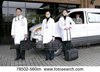 Stock Photo - healthcare professionals 
standing by vehicle. 
fotosearch - search 
stock photos, 
pictures, images, 
and photo clipart