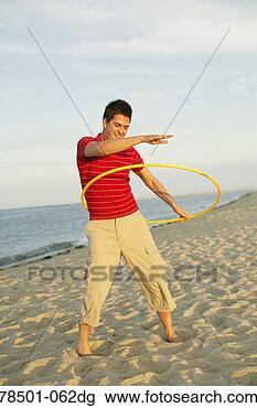 Stock Photo - man playing with 
toy hoop on beach. 
fotosearch - search 
stock photos, 
pictures, images, 
and photo clipart