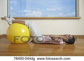 Stock Photo - woman on cell 
phone and exercising 
with exercise 
ball. fotosearch 
- search stock 
photos, pictures, 
images, and photo 
clipart
