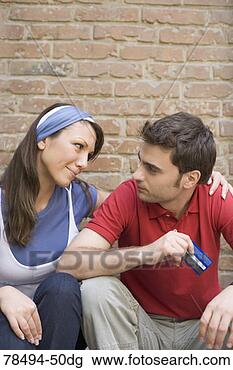 Stock Photo - woman consoling 
man with bank 
card. fotosearch 
- search stock 
photos, pictures, 
images, and photo 
clipart