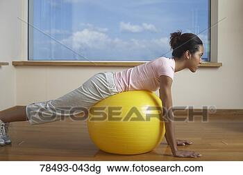 Stock Photo - woman exercising 
with exercise 
ball. fotosearch 
- search stock 
photos, pictures, 
images, and photo 
clipart