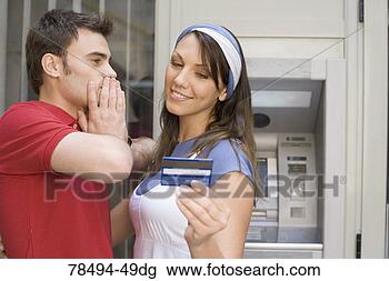 Stock Photo - woman looking 
at bank card with 
man looking at 
her. fotosearch 
- search stock 
photos, pictures, 
images, and photo 
clipart