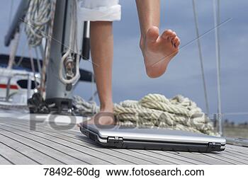 Stock Photo - woman stepping 
on laptop. fotosearch 
- search stock 
photos, pictures, 
images, and photo 
clipart