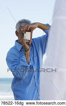 Stock Photo - man taking photo. 
fotosearch - search 
stock photos, 
pictures, images, 
and photo clipart