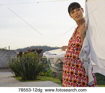 Stock Photo - woman hanging 
laundry on clothesline. 
fotosearch - search 
stock photos, 
pictures, images, 
and photo clipart