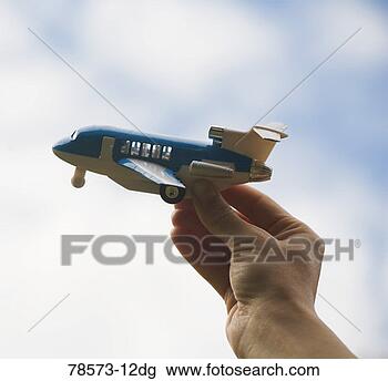 Stock Photo - hand holding toy 
airplane. fotosearch 
- search stock 
photos, pictures, 
images, and photo 
clipart