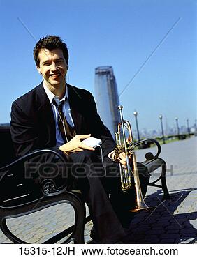 Stock Photo - young businessman 
with digital music 
player and trumpet, 
 sitting on. fotosearch 
- search stock 
photos, pictures, 
images, and photo 
clipart