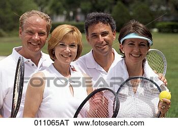 Stock Photo - a portrait of 
mixed doubles 
holding tennis 
rackets at a tennis 
court. fotosearch 
- search stock 
photos, pictures, 
images, and photo 
clipart