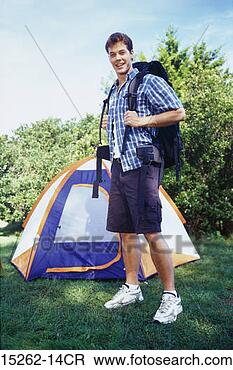 Stock Photo - a young adult 
caucasian male 
standing in front 
of a tent wearing 
a. fotosearch 
- search stock 
photos, pictures, 
images, and photo 
clipart