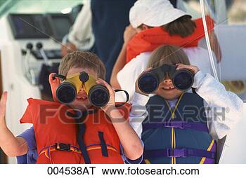 Stock Photo - boys in life jackets 
looking through 
binoculars from 
a boat. fotosearch 
- search stock 
photos, pictures, 
images, and photo 
clipart