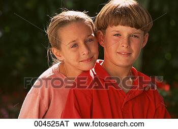 Stock Photo - portrait of boy 
and girl, girl 
is leaning over 
boy's shoulder. 
fotosearch - search 
stock photos, 
pictures, images, 
and photo clipart