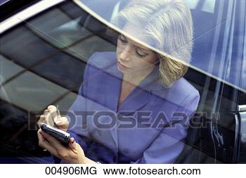 Stock Photo - businesswoman 
entering information 
into personal 
data assistant 
while. fotosearch 
- search stock 
photos, pictures, 
images, and photo 
clipart