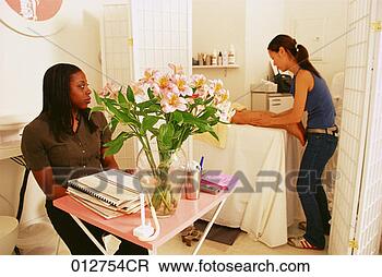Stock Photo - african-american 
receptionist watching 
another woman 
getting her legs. 
fotosearch - search 
stock photos, 
pictures, images, 
and photo clipart