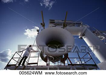Stock Photo - man standing beside 
jet engine test 
stand. fotosearch 
- search stock 
photos, pictures, 
images, and photo 
clipart